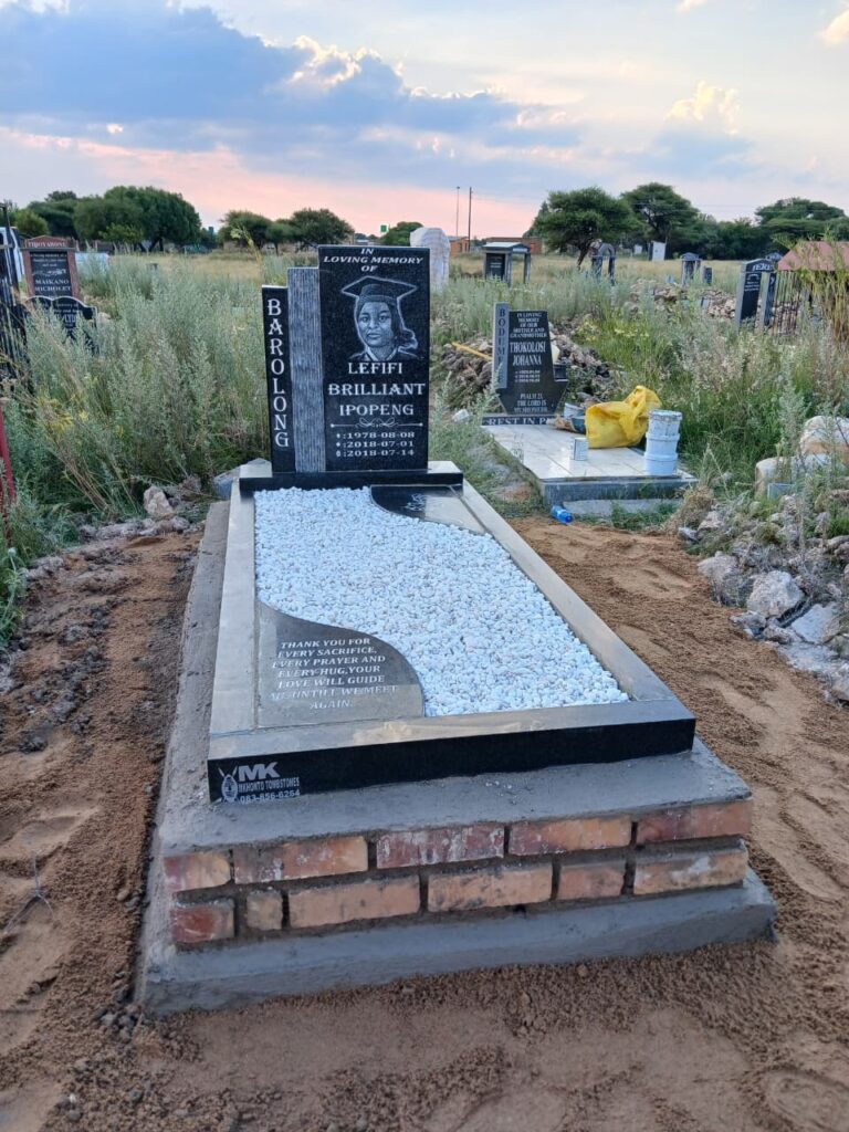 Beautiful black granite tombstone with white stone grave covering at Koikoi B2 Cemetery Mahikeng