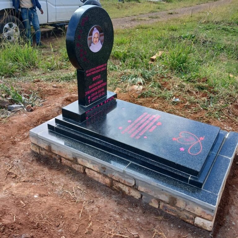 Close-up of black granite baby tombstone with ceramic photo portrait and pink laser-engraved inscription at South Park Cemetery Germiston 2