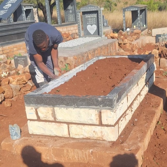 Mkhonto Tombstones team building a stone foundation for a tombstone in a rural Mpumalanga cemetery