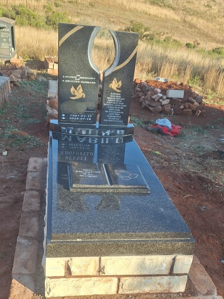 Mkhonto Tombstones installer finishing the granite surround on a family memorial