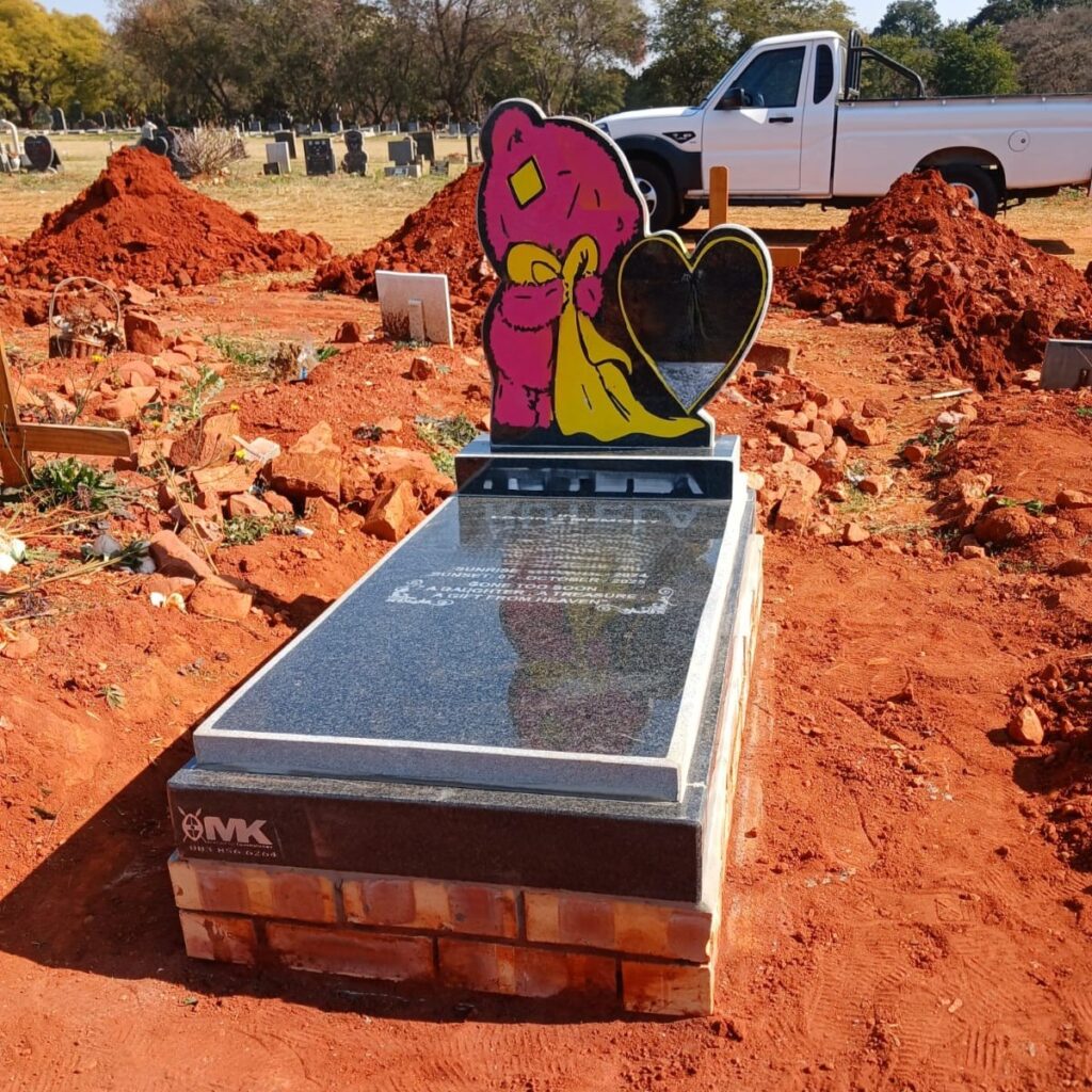 Custom granite tombstone with pink teddy bear and heart design at Westpark Cemetery, Johannesburg